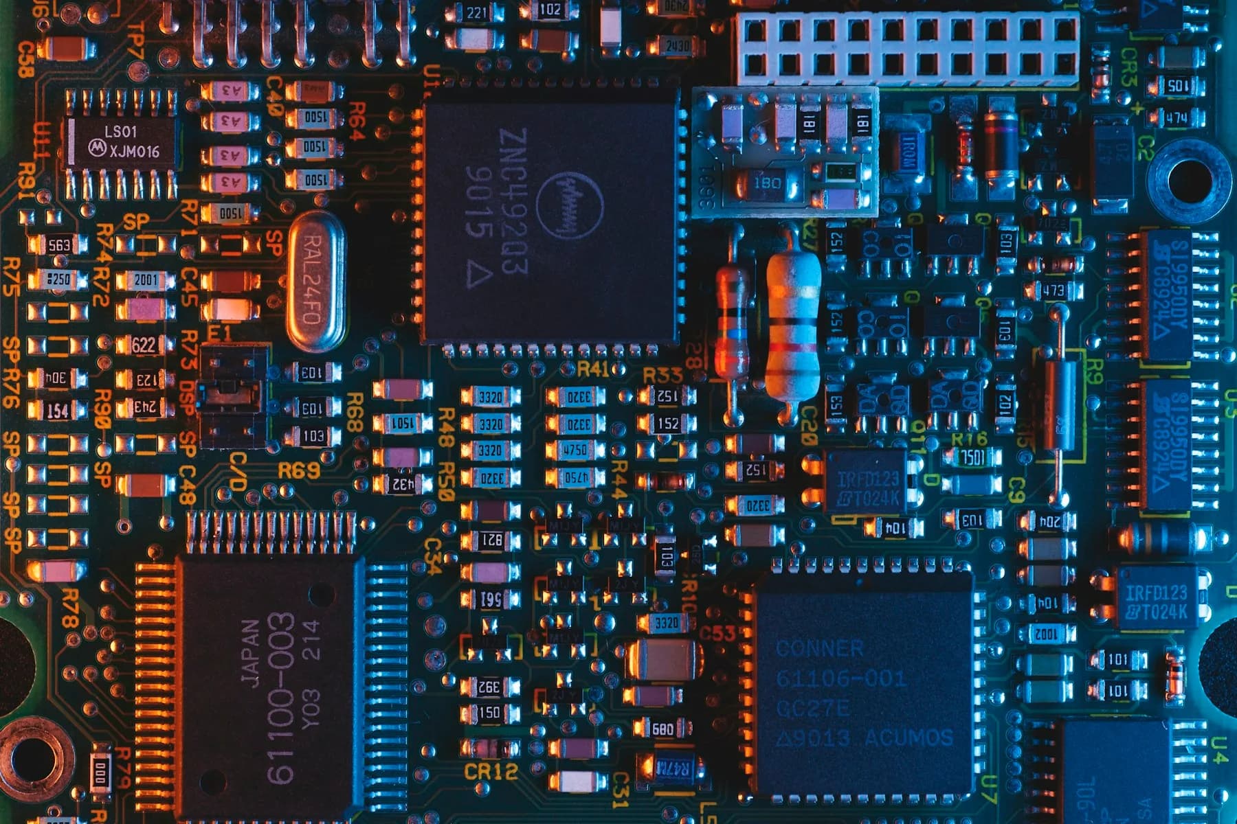 Detailed circuit board with orange and blue electrical connections